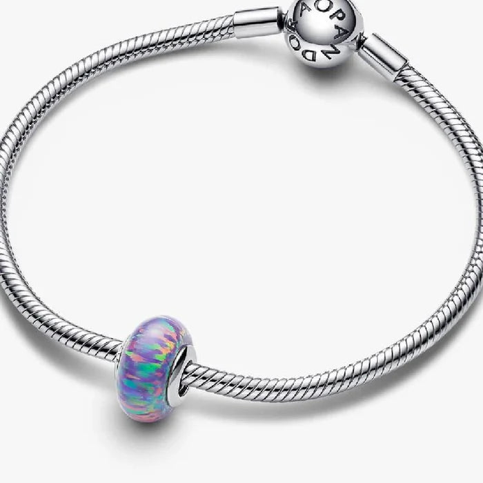 This Pandora Opalescent Purple Charm adds an enchanting pop of color to your jewelry collection.