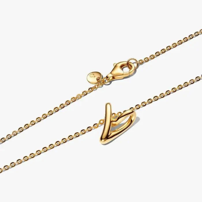 Close‑up of 14k gold‑plated openwork heart pendant with diamond‑cut chain and clasp visible