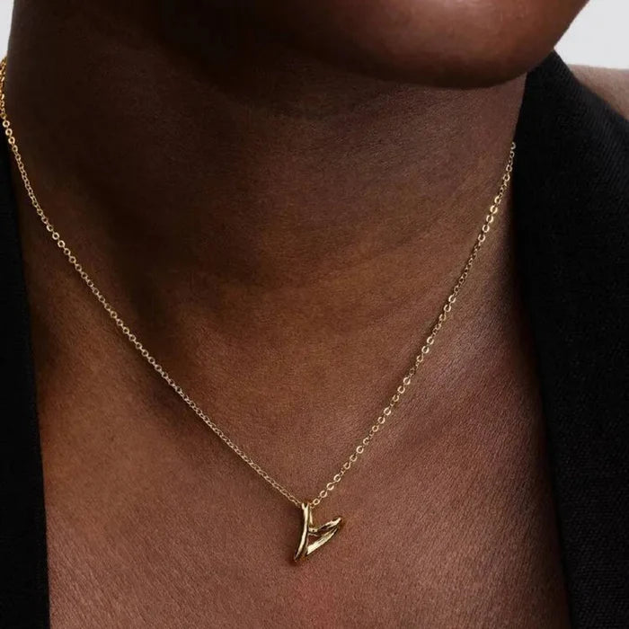 14k gold‑plated heart pendant worn at one of its adjustable lengths on the neckline