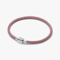 A pink braided leather bracelet featuring a sleek silver clasp.