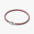 Pink cord bracelet with sterling silver clasp worn on the wrist