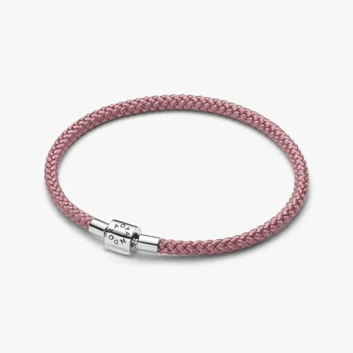 Pink cord bracelet with sterling silver clasp worn on the wrist