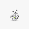 A silver and green enamel charm shaped like a snail, showcasing intricate detailing and vibrant colors.