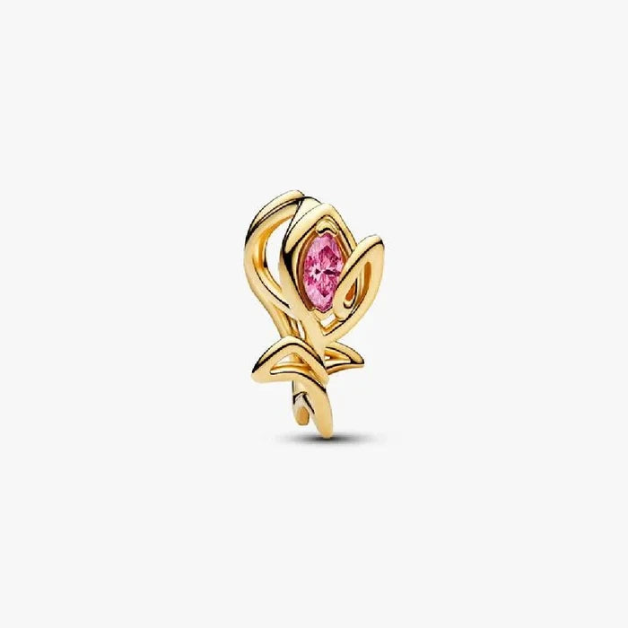 Gold plated rose charm adorned with pink stones, showcasing elegance and beauty in a delicate design.