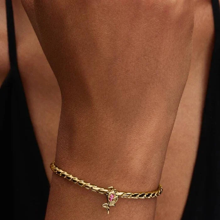 A charming gold plated rose with pink stones, highlighting a graceful and romantic aesthetic in jewelry.