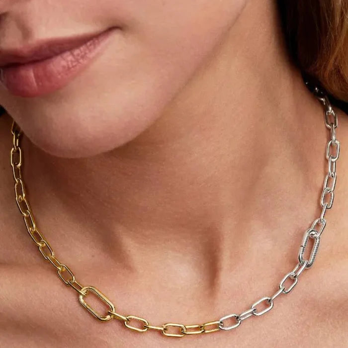 Close-up of a woman wearing the Pandora Two-Tone Link Chain Necklace featuring two openable links and a carabiner clasp.