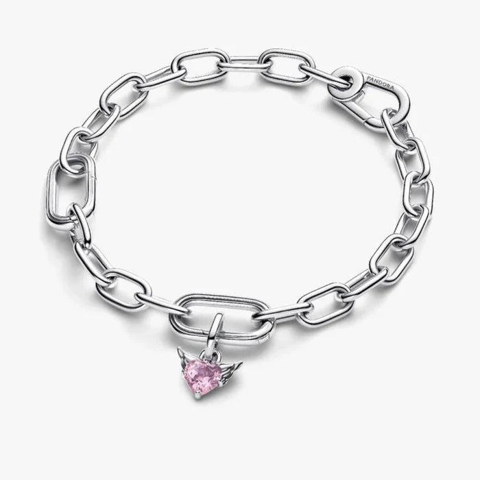 Close‑up of winged heart charm featuring pink crystal and heart cut‑out on a chain
