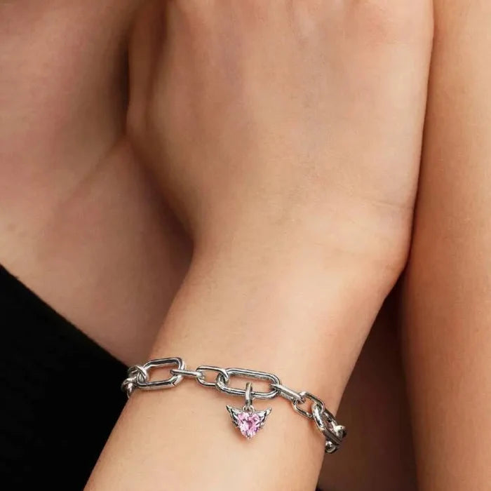 Winged heart mini dangle charm with pink crystal worn on a bracelet