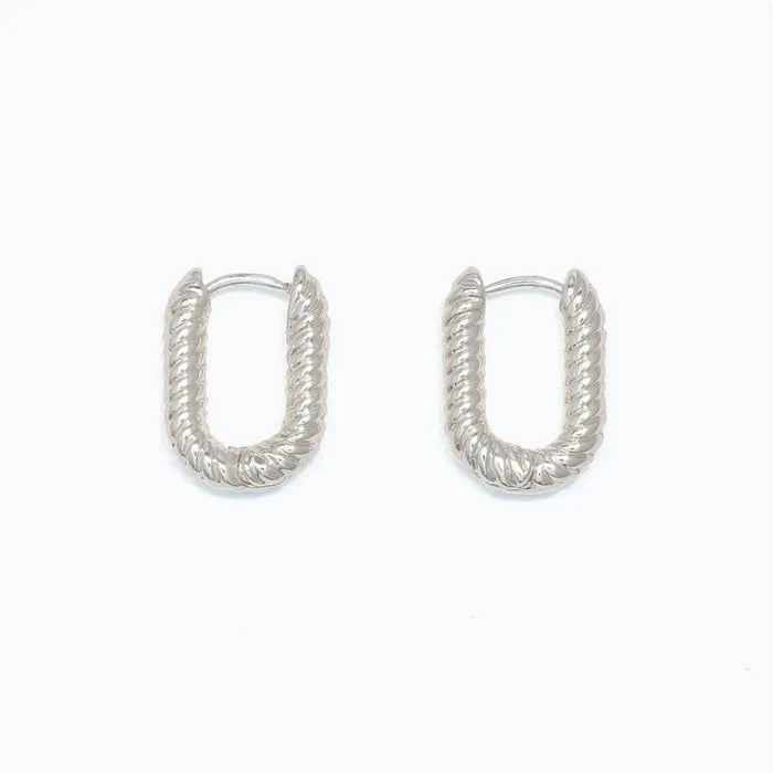Periwinkle chic ribbed silver huggie earrings featuring a textured finish and compact hoop design