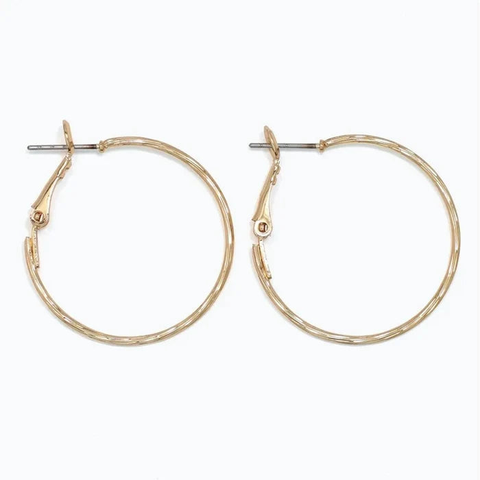 Periwinkle delicately textured gold hoop earrings with a classic silhouette and refined finish