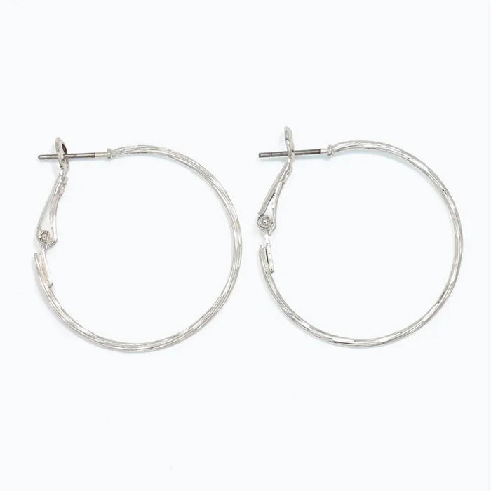 Periwinkle delicately textured silver hoop earrings with a classic silhouette and refined finish