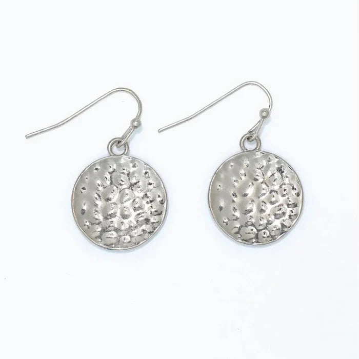 Hammered silver circle earrings featuring a textured finish and classic round design