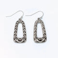 Open silver filigree drop earrings featuring an intricate openwork design