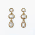 Pearl drop earrings featuring organic gold shapes and elegant warm metallic accents