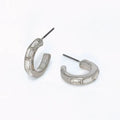 Silver hoop earrings featuring clear crystal accents and a polished elegant design