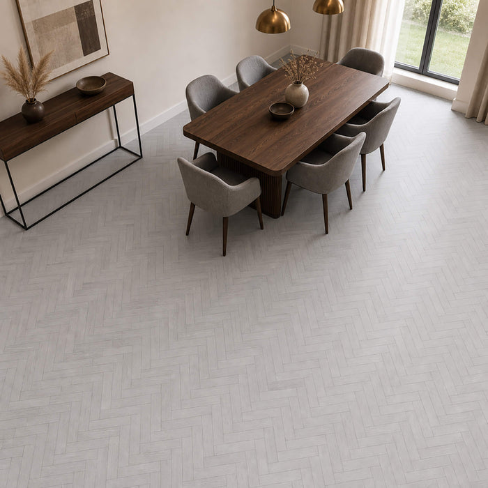 Pyrenees Oak rigid LVT Herringbone flooring in a dining room setting.