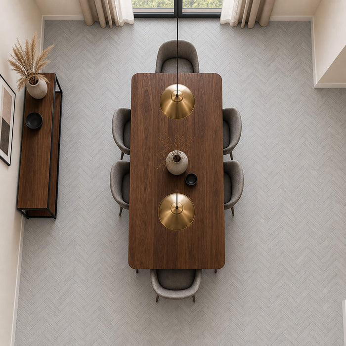 Elevated view of Pyrenees Oak rigid LVT Herringbone flooring in a dining room setting.