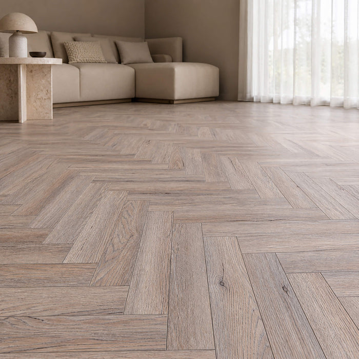 Riviera Oak rigid LVT herringbone flooring in a living room setting.