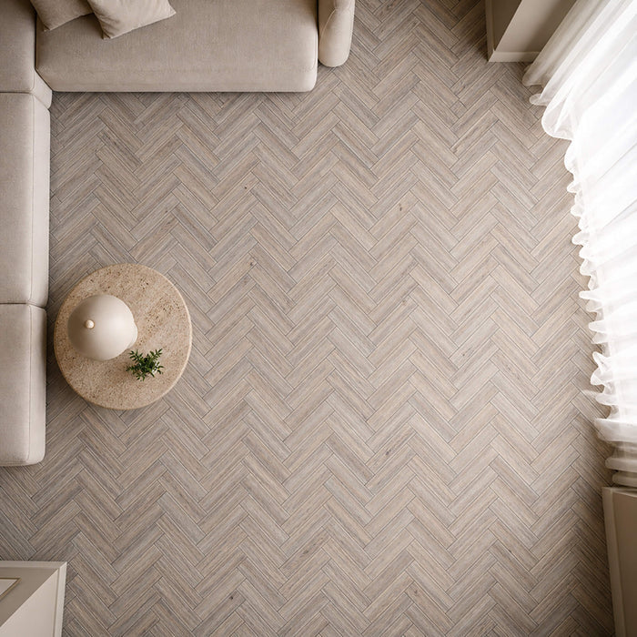 Elevated view of Riviera Oak rigid LVT herringbone flooring in a living room setting.