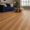 Sable Oak Prestige Plus laminate flooring in a home living room setting with a blue sofa and coffee table.