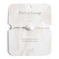 A white pearl bracelet adorned with green stones, showcasing an elegant and sophisticated design.