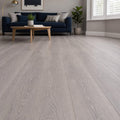 Living room with a blue sofa, wooden coffee table, and Sequoia Oak Country laminate flooring.
