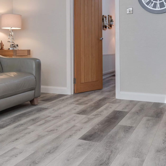 Silver Grey Oak Prestige laminate flooring in a living room setting looking into a dining room.