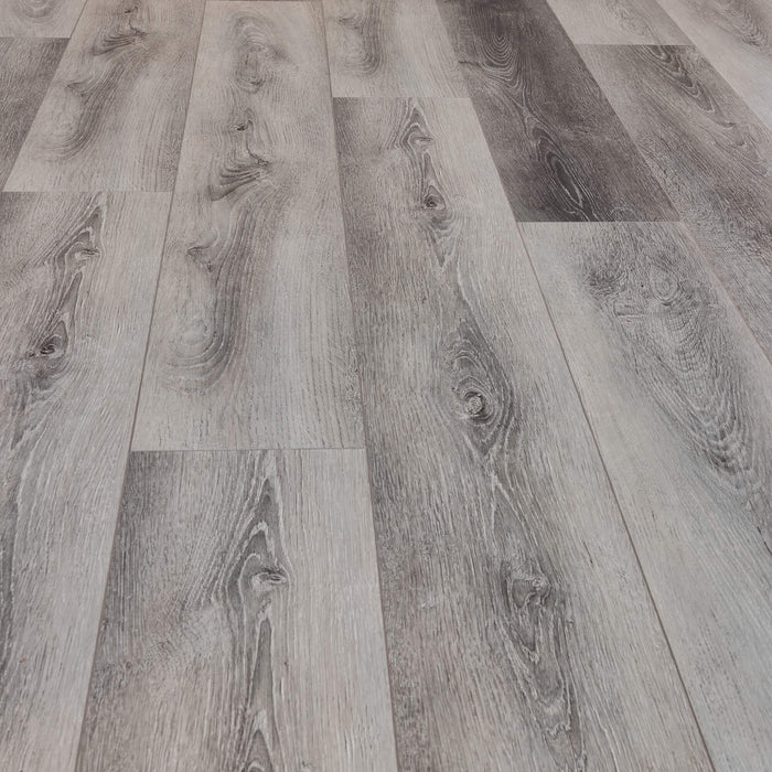 Close-up of Silver Grey Oak Prestige Laminate flooring on a living room floor.