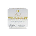 A stylish bracelet adorned with gold beads and pearls, showcasing a blend of luxury and elegance.