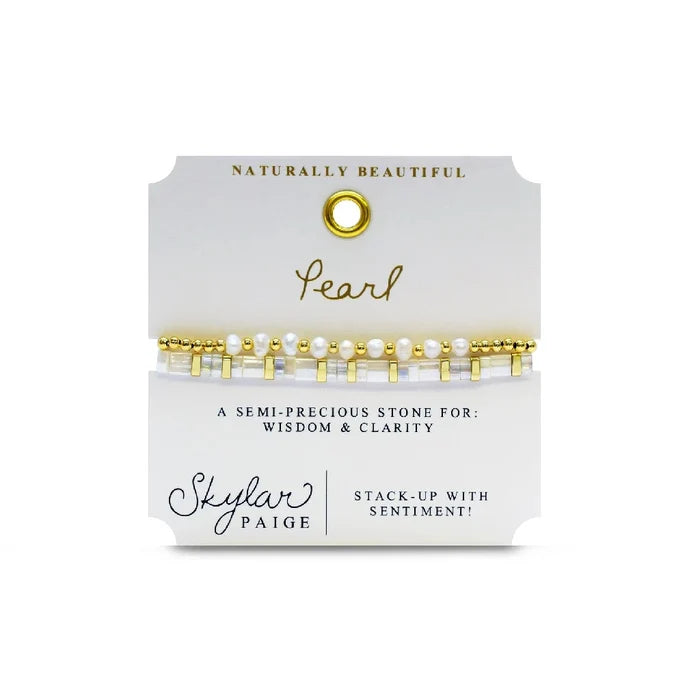 A stylish bracelet adorned with gold beads and pearls, showcasing a blend of luxury and elegance.