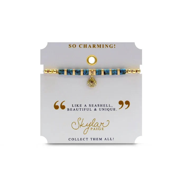 Elegant gold bracelet adorned with turquoise beads and a charming gold leaf pendant, perfect for any occasion.