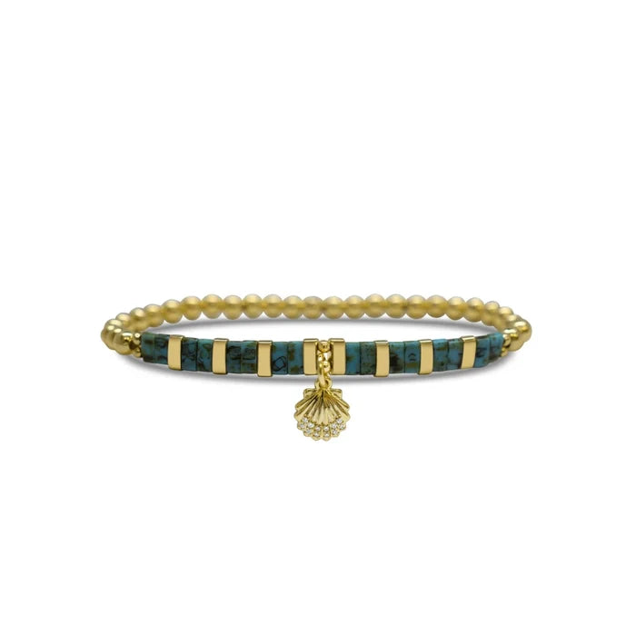 . Gold bracelet featuring turquoise beads and a delicate gold leaf charm, showcasing a blend of elegance and nature.