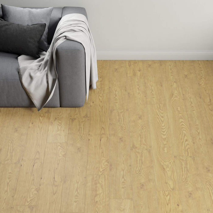 Tawny Chestnut Laminate Flooring in a living room setting with a sofa in the corner.