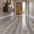 Modern hallway with Uptown Oak Gloss laminate flooring. door, and wall-mounted cabinet.