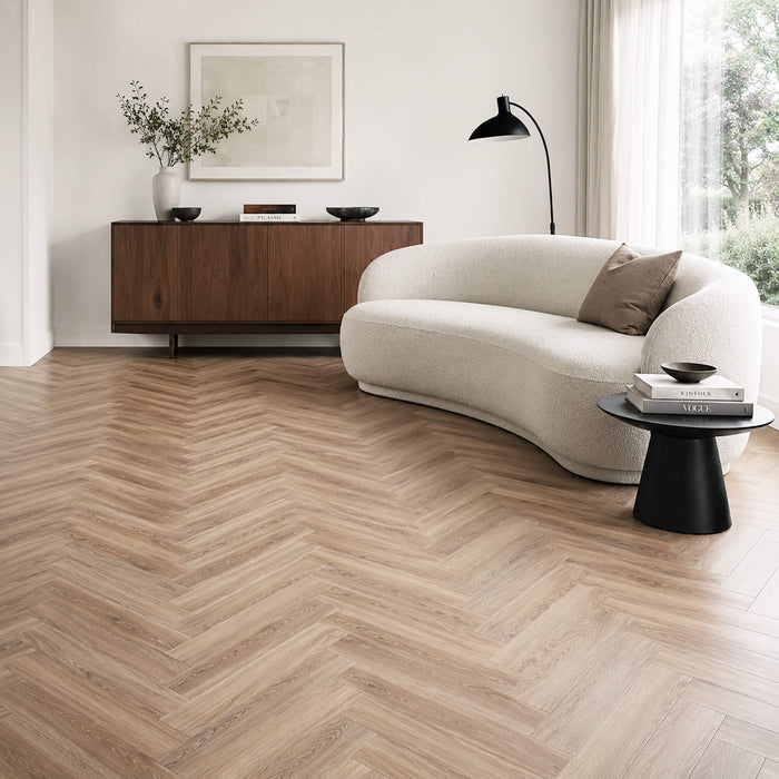 Volcanic Larch Rigid LVT Herringbone flooring in a living room setting.