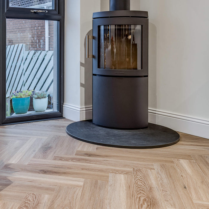 Volcanic Larch Rigid LVT Herringbone Flooring in a sun room setting.