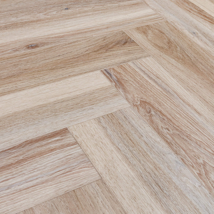 Close-up of the grain and texture of Volcanic Larch Rigid LVT Herringbone Flooring.