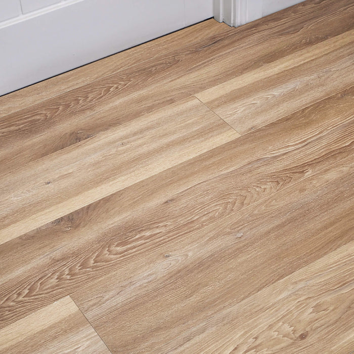Volcanic Larch Rigid LVT Flooring with white architrave and door in the background.