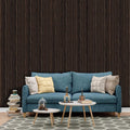 Blue sofa with decorative pillows in a living room setting with walnut slatwall.