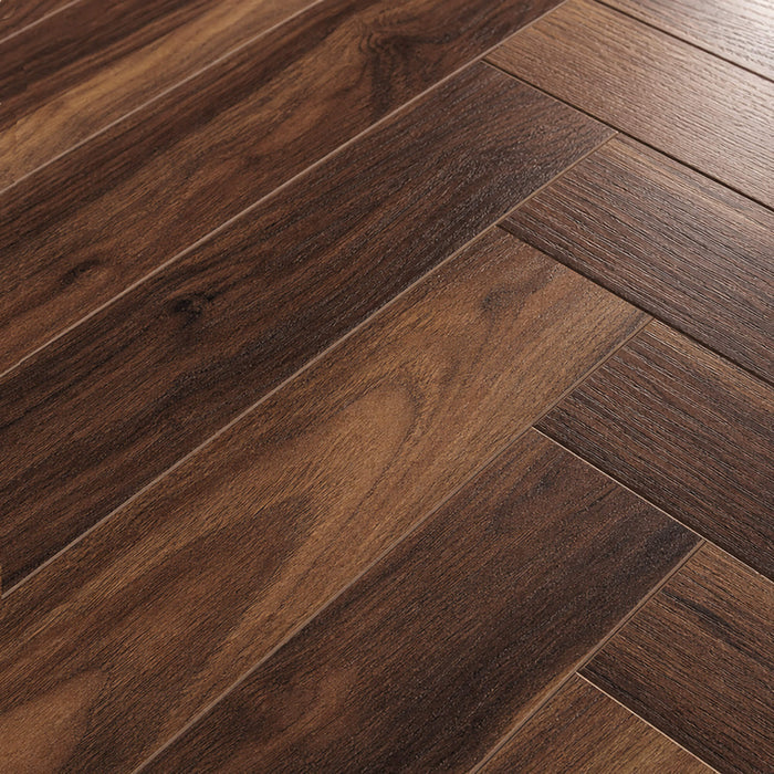 Close-up of the grain and texture of Walnut Herringbone laminate flooring.