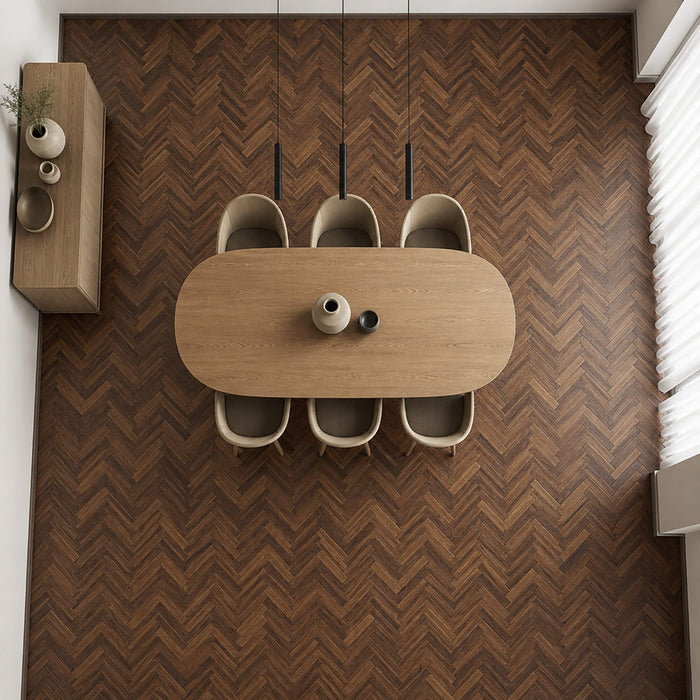 Elevated view of Walnut Herringbone laminate flooring in a dining room setting.