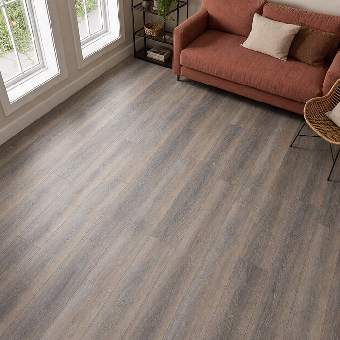 Weathered Oak Prestige laminate flooring  in a living room setting with a red sofa.
